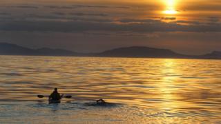 Kayaker and swimmer