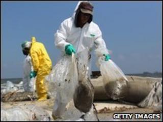 A BP clean-up crew removes oil from a beach in Louisiana