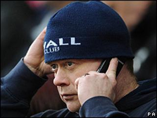Millwall football fan using mobile phone