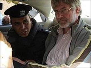 Swiss businessman Max Goeldi (C) leaves the Swiss embassy on 22 February