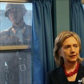 A North Korean soldier watches Mrs Clinton on a visit to the DMZ