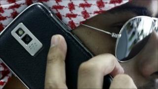 An Arabian man speaks on his BlackBerry