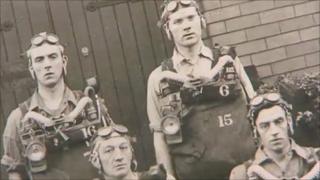 Old photograph of miners in rescue equipment