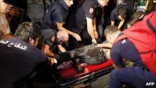 An injured man is treated by paramedics in Beirut (24 August 2010)