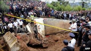 Guatemalan bus smashed by landslide surrounded by rescuers