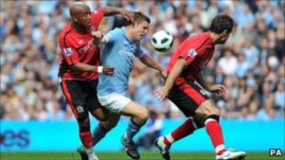 Manchester City's James Milner (centre) battles with Blackburn Rovers' El-Hadji Diouf (left) and Ryan Nelson during the match at the City of Manchester Stadium