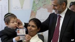 Sandra Samuel displays her new Israeli identification card
