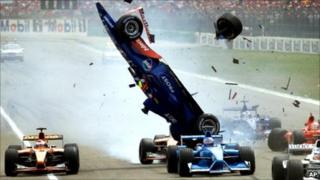 The Prost racer of Brazilian Luiciano Burti is up in the air while debris flies around after a crash at the start of the German Formula 1 Grand Prix at the Hockenheim track, Germany, Sunday, July 29, 2001.