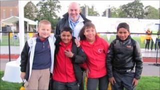 Lauren Nelson, 10, with Jerry Hirst (head teacher of Sacred Heart school in the city of Leicester), Rivaldo Remedios, 10, Jerin James, 10, Krystian Klonowski, 10