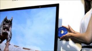 Model holds a Blu-ray disc