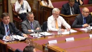 Bankers sitting before a Stormont committee