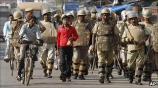 Indian security personnel patrol a street in Ayodhya