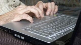 Man typing on laptop computer - generic image