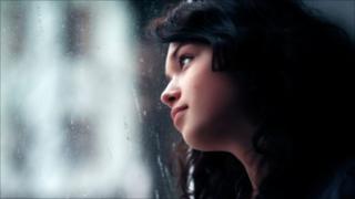 Woman gazing out of window