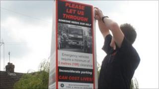 Firefighter putting up poster