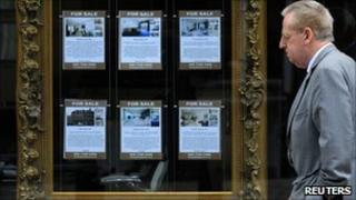 Man passes estate agent's window