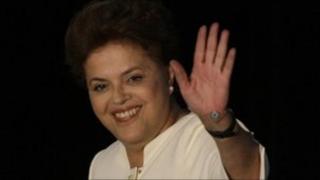Dilma Rousseff waves to supporters after the election results are announced