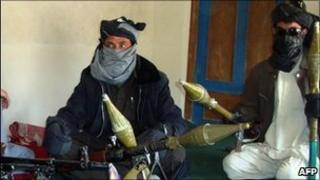 Taliban fighters display their weapons