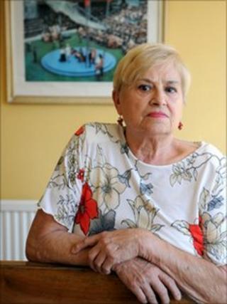 Jean Thomas with the photo hanging in the background