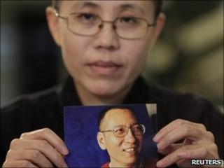 Liu Xia holds a photo of her husband Liu Xiaobo