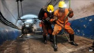 Rescuers prepare to go underground after the leak at the mine in Yuzhou