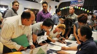 Unemployment Americans attend a job fair in California