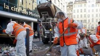 French waste collectors clean up a street in Marseille, 26 October