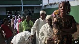 Voters wait in line to cast their ballot in the first round of presidential elections in Abidjan, Ivory Coast, 31 November
