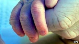 Holding a baby's hand