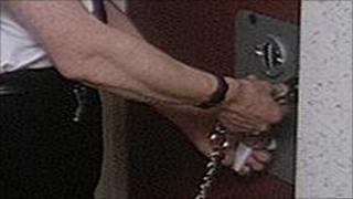 Guard locking prison door