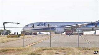 The 787 is examined by emergency services and investigators