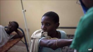 A woman suffering from cholera symptoms is checked by a Cuban doctor at the hospital in Archaie, Haiti, Tuesday Nov. 9, 2010.