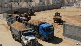 Lorries are loaded with sand for UN building projects in Gaza - 7 October 2010