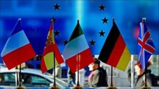 Five european flags on a table