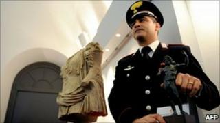 Michele Speranza, who spotted the stolen torso for sale in New York, pictured with the statues at a Rome press conference, 19 November 2010
