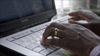 Hands on a laptop keyboard
