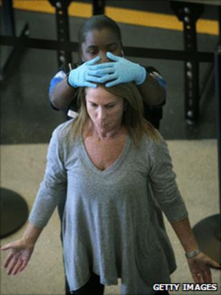 A traveller at a US airport being inspected