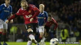 Wayne Rooney tucks away a late penalty at Ibrox