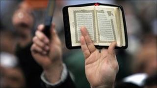 Koran held aloft (generic)