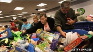 Shoppers search bins for toys at a Goodwill thrift store in Denver on Black Friday