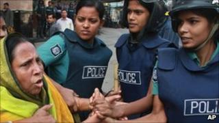 Police drag away a protester in Dhaka on 30 November 2010