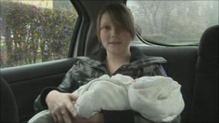 Jade and baby Caleb in the back of the car