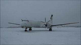 Plane covered in snow at Guernsey Airport