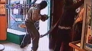 The men attaching the strap to the cash machine