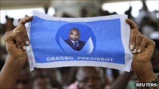 Supporter of Laurent Gbagbo holding poster (15 December 2010)
