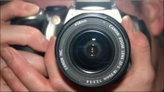 hand holding SLR camera