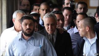 Moshe Katsav leaves court after hearing the verdict in his trial for rape