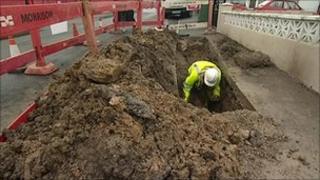 Man carries out water mains repairs