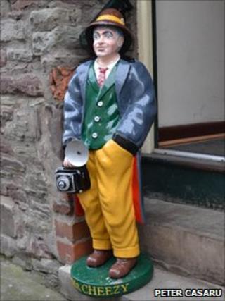 Mr Cheezy on the step outside the shop