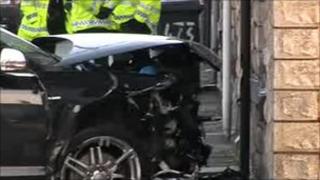 The black Audi hit a property